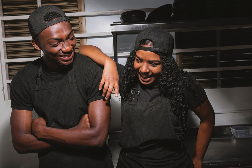Happy Male and Female Cooks in the Kitchen